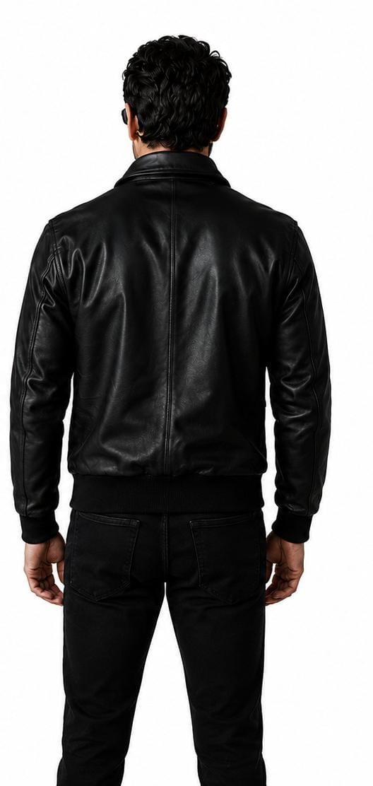 A man viewed from behind wearing a black leather jacket and black pants against a plain white background.