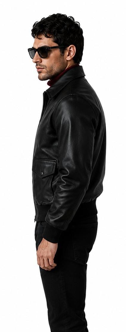 A man in profile wearing a black leather jacket, black pants, and black sunglasses against a plain white background.