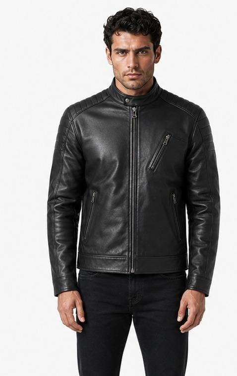 A man wearing a black leather biker jacket with a front zipper, zippered chest pocket, and zippered hand pockets, paired with black jeans, against a plain white background.